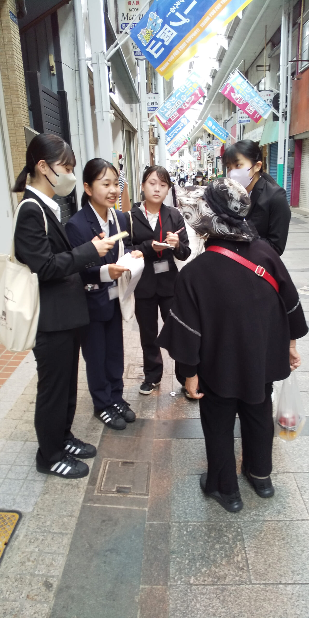 岡山済生会看護専門学校の学生4人が地域住民の方にインタビューしている写真